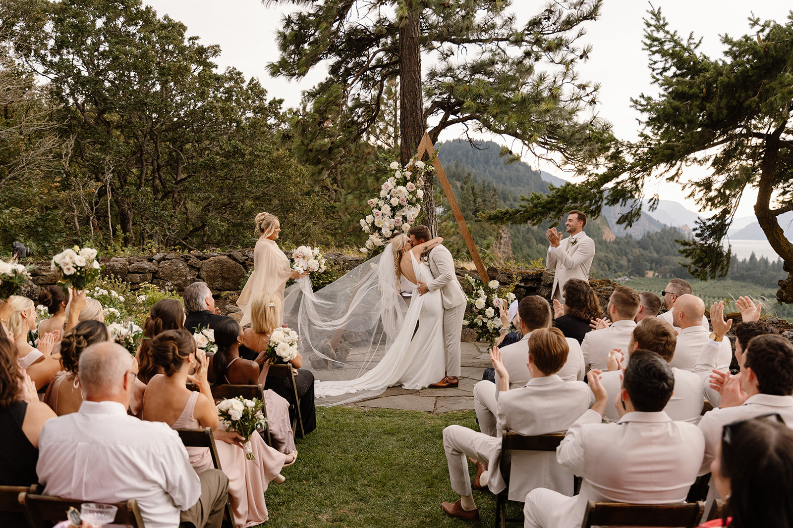 Bride and Groom exchanging their first kiss on the terrace at the griffin house in hood river