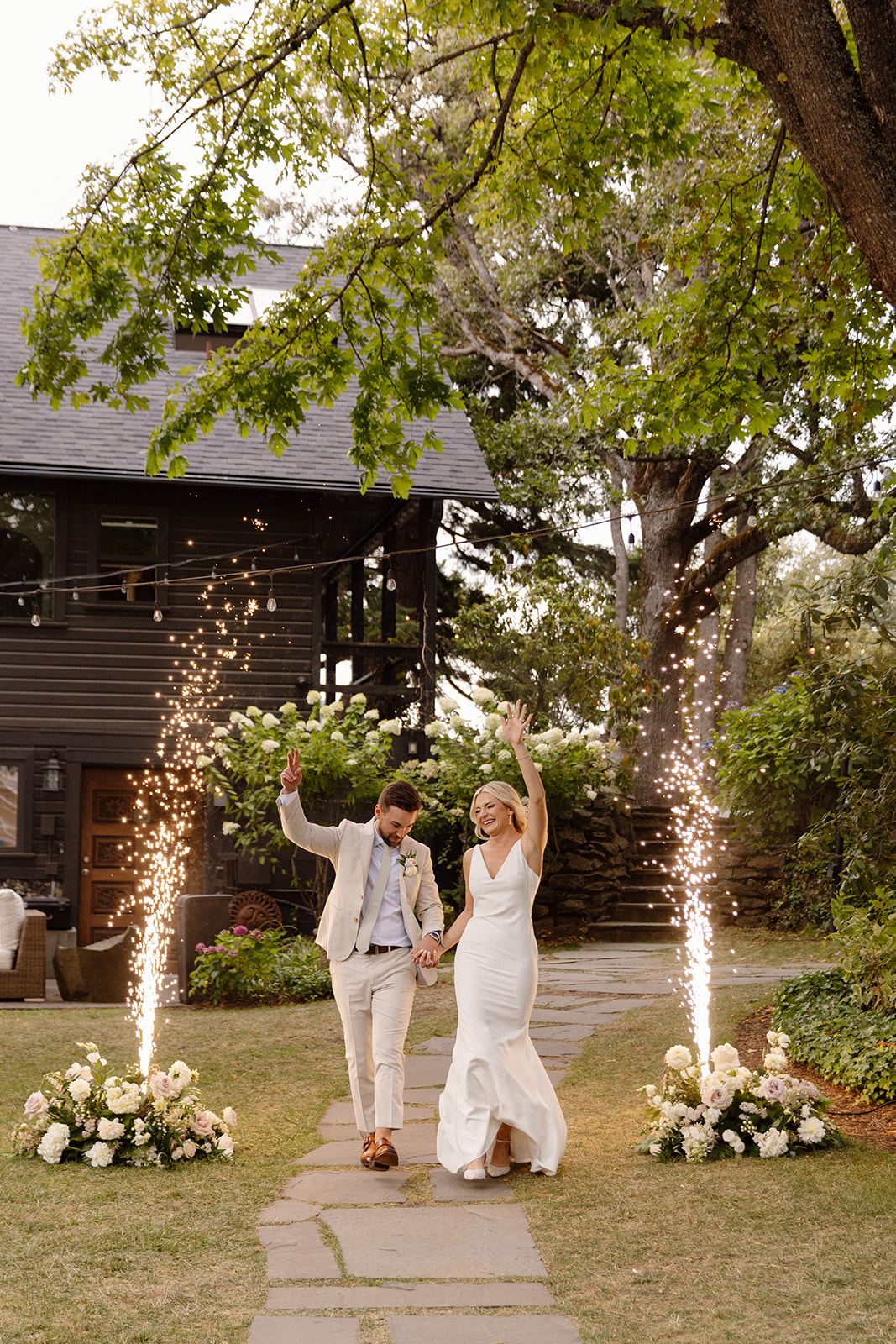 Bride and groom entering with fireworks to their reception at the griffin house.