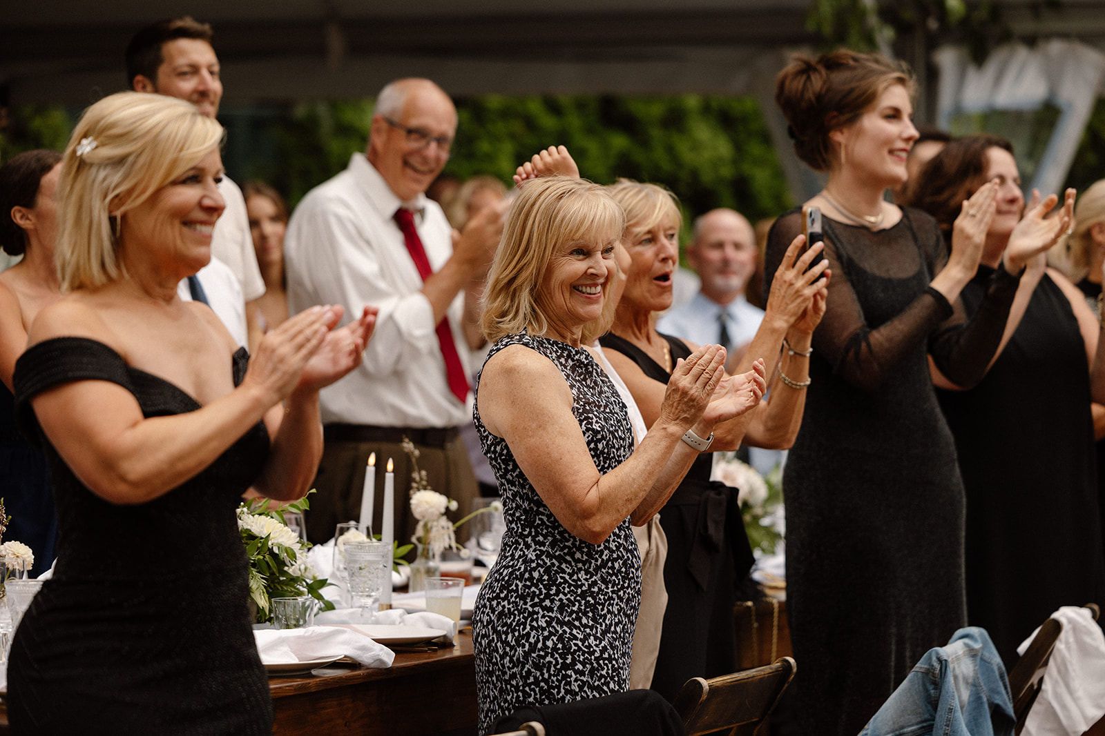 guests cheering for the bride and groom during their grand entrance as newlyweds at The Griffin House