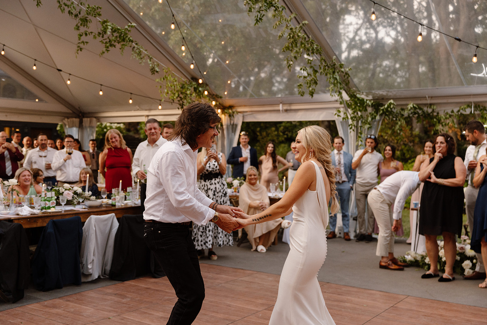Bride and father sharing a heartfelt dance, surrounded by family and friends at The Griffin House