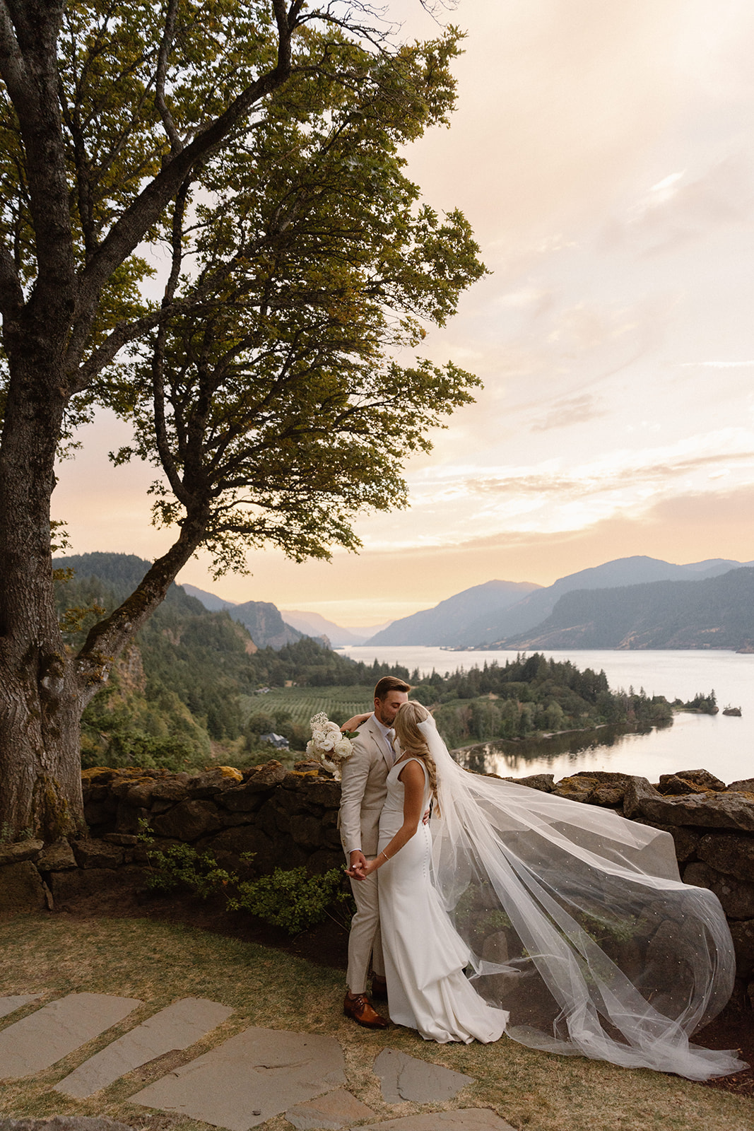 bride and groom taking couple pictures at sunset at the griffin house