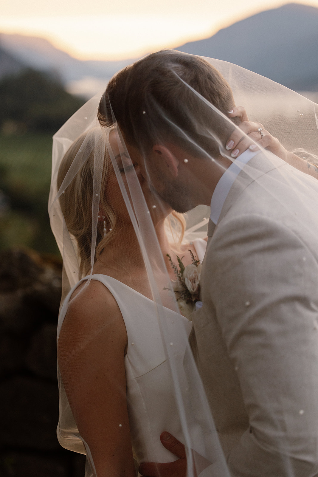 Couple sharing a tender moment during a picturesque sunset at The Griffin House.
