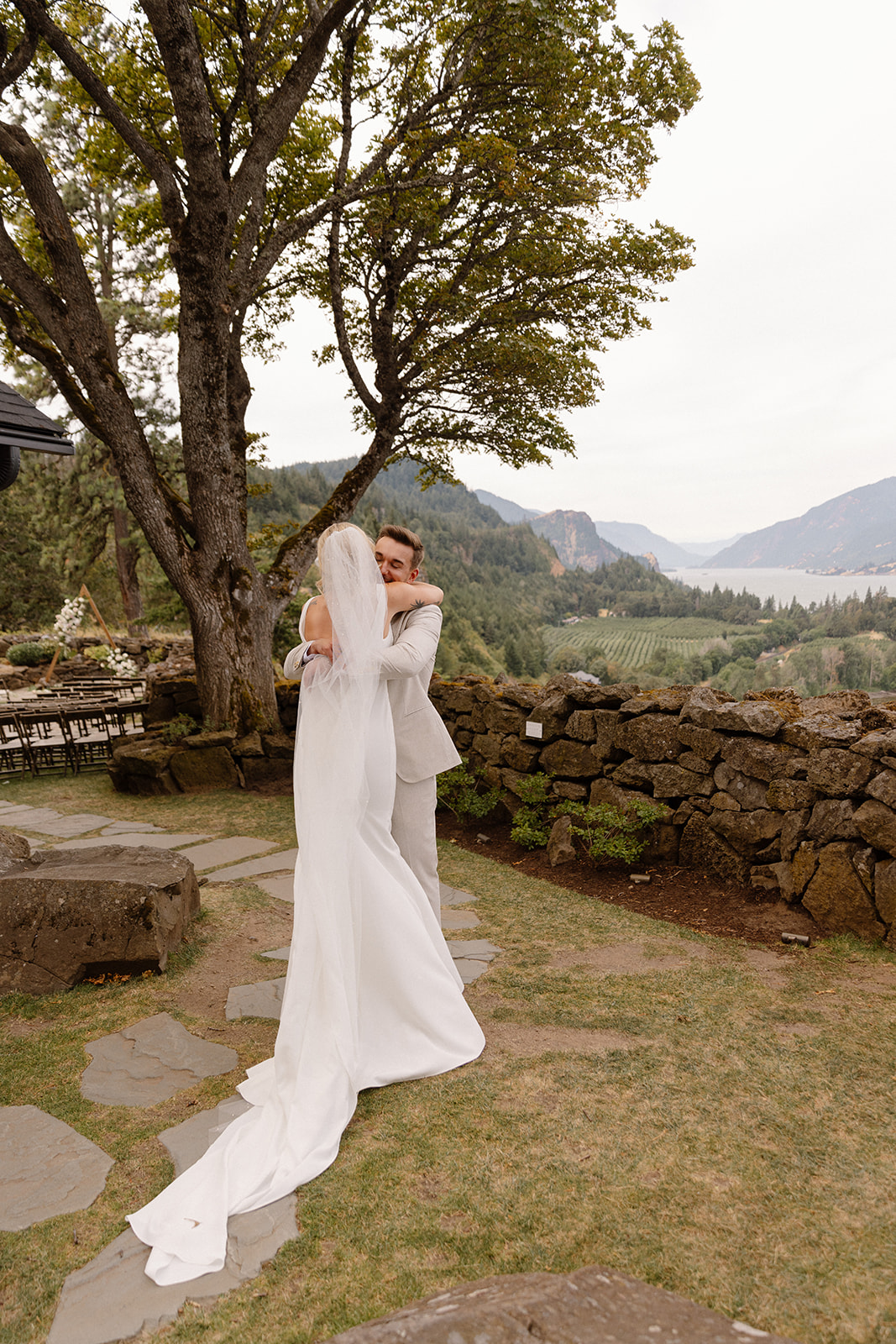 Groom hugging the bride during the first look at the griffin house in hood river