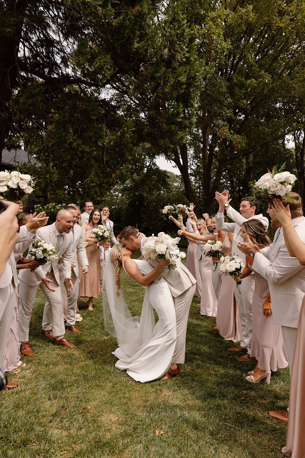 Bridal party posing together on the lush grounds of The Griffin House.