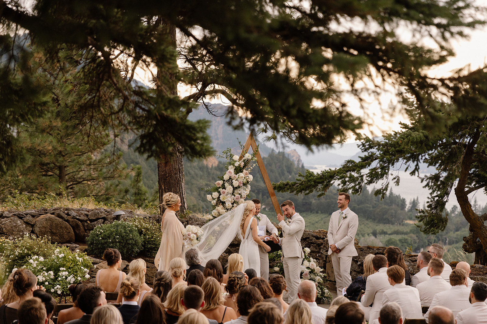 Groom wiping his tears at The Griffin House surrounded by lush greenery and fresh blooms.