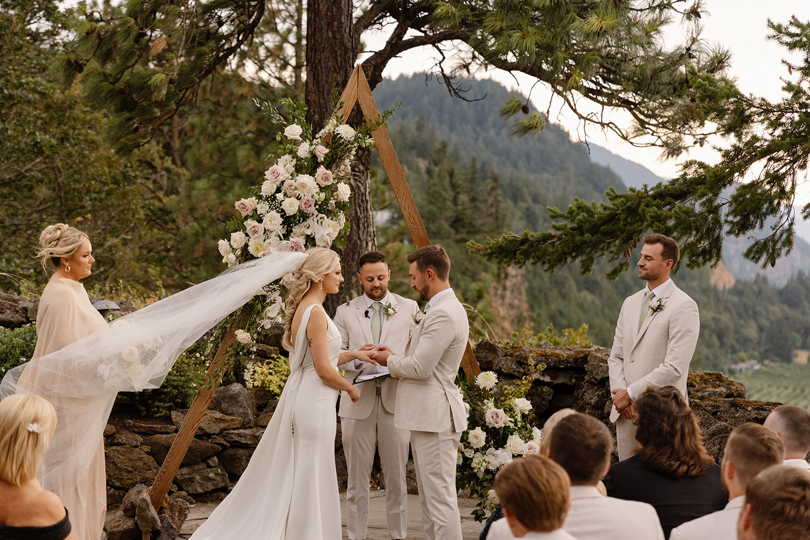 Bride and groom exchanging rings during the ceremony on the terrace at The Griffin House.